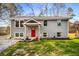 Charming gray brick home featuring a bright red front door and well-manicured lawn at 2831 Spruce Point Rd, South Fulton, GA 30349
