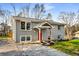 Beautifully remodeled brick home with gray paint, showcasing a welcoming front porch and fresh landscaping at 2831 Spruce Point Rd, South Fulton, GA 30349