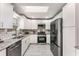 Updated kitchen featuring granite countertops, white cabinetry and stainless steel appliances at 2831 Spruce Point Rd, South Fulton, GA 30349
