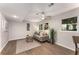Bright living room features wood-look flooring, a modern ceiling fan, an accent rug, and a comfortable couch at 2831 Spruce Point Rd, South Fulton, GA 30349