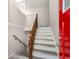 Traditional staircase with wood banister and a red front door at 2831 Spruce Point Rd, South Fulton, GA 30349