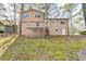 View of backyard featuring a deck, lush lawn, and two-story home with a neutral exterior at 1037 Martin Rd, Stone Mountain, GA 30088