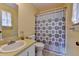 Bathroom featuring patterned curtain, neutral color scheme, and vanity with integrated sink at 1037 Martin Rd, Stone Mountain, GA 30088