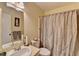 Bright bathroom featuring a shower with patterned curtain, neutral color scheme, and vanity with integrated sink at 1037 Martin Rd, Stone Mountain, GA 30088