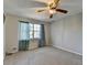 Neutral bedroom features standard ceiling fan, plush carpet, and good natural light at 1037 Martin Rd, Stone Mountain, GA 30088