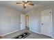 Carpeted bedroom with two doors, ceiling fan, and plush carpet at 1037 Martin Rd, Stone Mountain, GA 30088