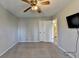 Carpeted bedroom with view of hall, mounted television, and double-door closet at 1037 Martin Rd, Stone Mountain, GA 30088