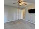 Carpeted bedroom with view of hall, mounted television, and double-door closet at 1037 Martin Rd, Stone Mountain, GA 30088