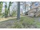 The exterior shows a spacious backyard with mature trees and the back of the home and deck at 1037 Martin Rd, Stone Mountain, GA 30088