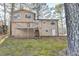 The backyard with mature trees and a wooden deck attached to the house at 1037 Martin Rd, Stone Mountain, GA 30088