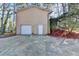 Garage and driveway surrounded by mulch beds and wooded areas at 1037 Martin Rd, Stone Mountain, GA 30088