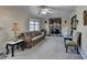 Living room featuring a stone fireplace, neutral carpet, and window providing natural light at 1037 Martin Rd, Stone Mountain, GA 30088