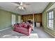 Spacious bedroom with a four-poster bed, neutral carpet, and large windows at 1037 Martin Rd, Stone Mountain, GA 30088