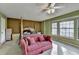 Bedroom with a four-post bed, pink couch, neutral carpet, and large windows at 1037 Martin Rd, Stone Mountain, GA 30088