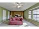 Bedroom with a four-post bed, pink couch, neutral carpet, and large windows at 1037 Martin Rd, Stone Mountain, GA 30088