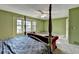 Main bedroom featuring four poster bed, sitting area, and neutral carpet and decor at 1037 Martin Rd, Stone Mountain, GA 30088