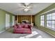 Bedroom with a four-post bed, pink couch, neutral carpet, and large windows at 1037 Martin Rd, Stone Mountain, GA 30088