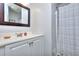 A well-lit bathroom featuring a mirror and shower curtain at 2493 Cherie Glen Trl, Snellville, GA 30039