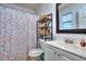 A functional bathroom featuring modern sink vanity, mirror and a decorative shower curtain at 2493 Cherie Glen Trl, Snellville, GA 30039