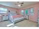 Relaxing main bedroom features a bay window, ceiling fan and light gray colored furniture at 2493 Cherie Glen Trl, Snellville, GA 30039