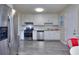 Kitchen with white cabinets, stainless appliances, light gray flooring, and subway tile backsplash at 2493 Cherie Glen Trl, Snellville, GA 30039