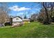 A spacious backyard featuring a well-maintained lawn, tiered landscaping and a deck for outdoor enjoyment at 260 Mansell Cir, Roswell, GA 30075