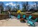 A concrete backyard patio features colorful seating around a fire pit, and tiered landscaping at 260 Mansell Cir, Roswell, GA 30075