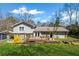 A spacious backyard featuring a lush lawn, landscaping and a deck and patio for outdoor living at 260 Mansell Cir, Roswell, GA 30075