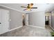 Spacious bedroom with neutral walls, plush carpet, and doors to bathroom and closet at 260 Mansell Cir, Roswell, GA 30075
