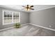 Cozy bedroom with neutral walls, plush carpet, and large window offering plenty of natural light at 260 Mansell Cir, Roswell, GA 30075