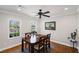 Bright dining room with hardwood floors, crown molding, and a modern ceiling fan fixture at 260 Mansell Cir, Roswell, GA 30075
