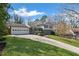 Attractive home with a long driveway, lush green grass, and neighboring house at 260 Mansell Cir, Roswell, GA 30075