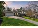 Inviting home exterior featuring a well-maintained lawn, classic design, and warm twilight lighting at 260 Mansell Cir, Roswell, GA 30075