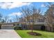 Beautiful home with well-manicured lawn, complemented by mature trees creating a picturesque setting at 260 Mansell Cir, Roswell, GA 30075