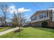 Inviting house with beautiful lawn complemented by lush landscaping and mature shade trees at 260 Mansell Cir, Roswell, GA 30075
