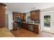 Kitchen with wood cabinets, stainless steel appliances, and access to the outdoor deck at 260 Mansell Cir, Roswell, GA 30075