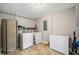 Functional laundry room featuring appliances and storage with tile flooring and neutral paint at 260 Mansell Cir, Roswell, GA 30075