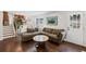 Comfortable living room featuring a brown sectional sofa, and a door to the backyard at 260 Mansell Cir, Roswell, GA 30075