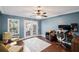 Well-lit office space with a ceiling fan, French doors, and views of the outdoors at 260 Mansell Cir, Roswell, GA 30075