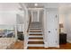 Classic staircase featuring hardwood steps, a light color scheme, and an open floor plan design at 260 Mansell Cir, Roswell, GA 30075