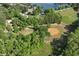 A bird's-eye view of a community ballfield amid dense trees and green space, with a serene lake visible at 320 Dodd Ln, Alpharetta, GA 30005