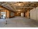 Spacious unfinished basement with concrete floor and exposed wooden beam ceiling at 320 Dodd Ln, Alpharetta, GA 30005