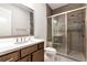 Bathroom featuring a shower with glass door and brown vanity at 320 Dodd Ln, Alpharetta, GA 30005