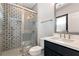 Updated bathroom featuring sleek vanity, decorative tile, framed mirror, shower with glass door at 320 Dodd Ln, Alpharetta, GA 30005