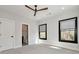 Sunlit bedroom with plush carpet, dark framed windows and view to the ensuite bathroom at 320 Dodd Ln, Alpharetta, GA 30005