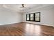 Bedroom features hardwood floors, a tray ceiling, large window, and neutral wall color at 320 Dodd Ln, Alpharetta, GA 30005