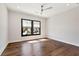 Bright bedroom features hardwood floors, ceiling fan and window overlooking the neighborhood at 320 Dodd Ln, Alpharetta, GA 30005