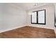 Bright bedroom features hardwood floors, recessed lighting, and a large window for natural light at 320 Dodd Ln, Alpharetta, GA 30005