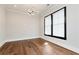 Bright bedroom features hardwood floors, white trim, and a modern geometric light fixture at 320 Dodd Ln, Alpharetta, GA 30005