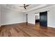 Bedroom boasts hardwood floors, modern sliding barn door, and tray ceilings at 320 Dodd Ln, Alpharetta, GA 30005